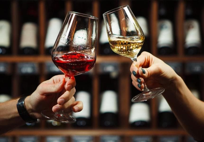 Two glasses of wine cheersing at the Good Land wine bar